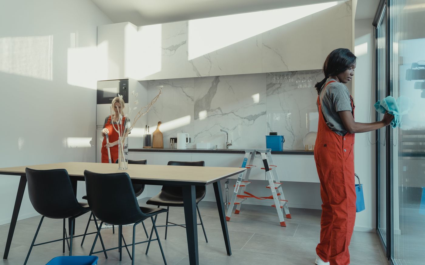 Professional cleaners at work in a bright open-plan space
